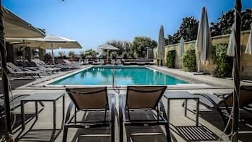 Seasonal outdoor pool, open 9 AM to 5 PM, pool umbrellas, pool loungers