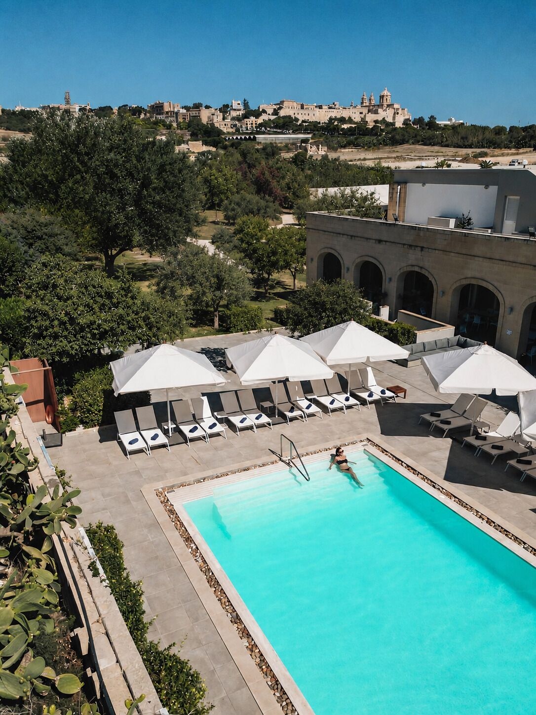 Seasonal outdoor pool, open 9 AM to 5 PM, pool umbrellas, pool loungers
