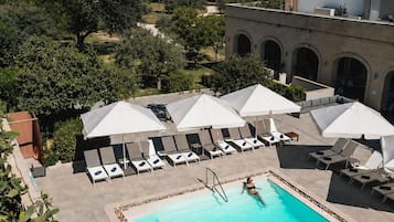 Seasonal outdoor pool, open 9 AM to 5 PM, pool umbrellas, pool loungers