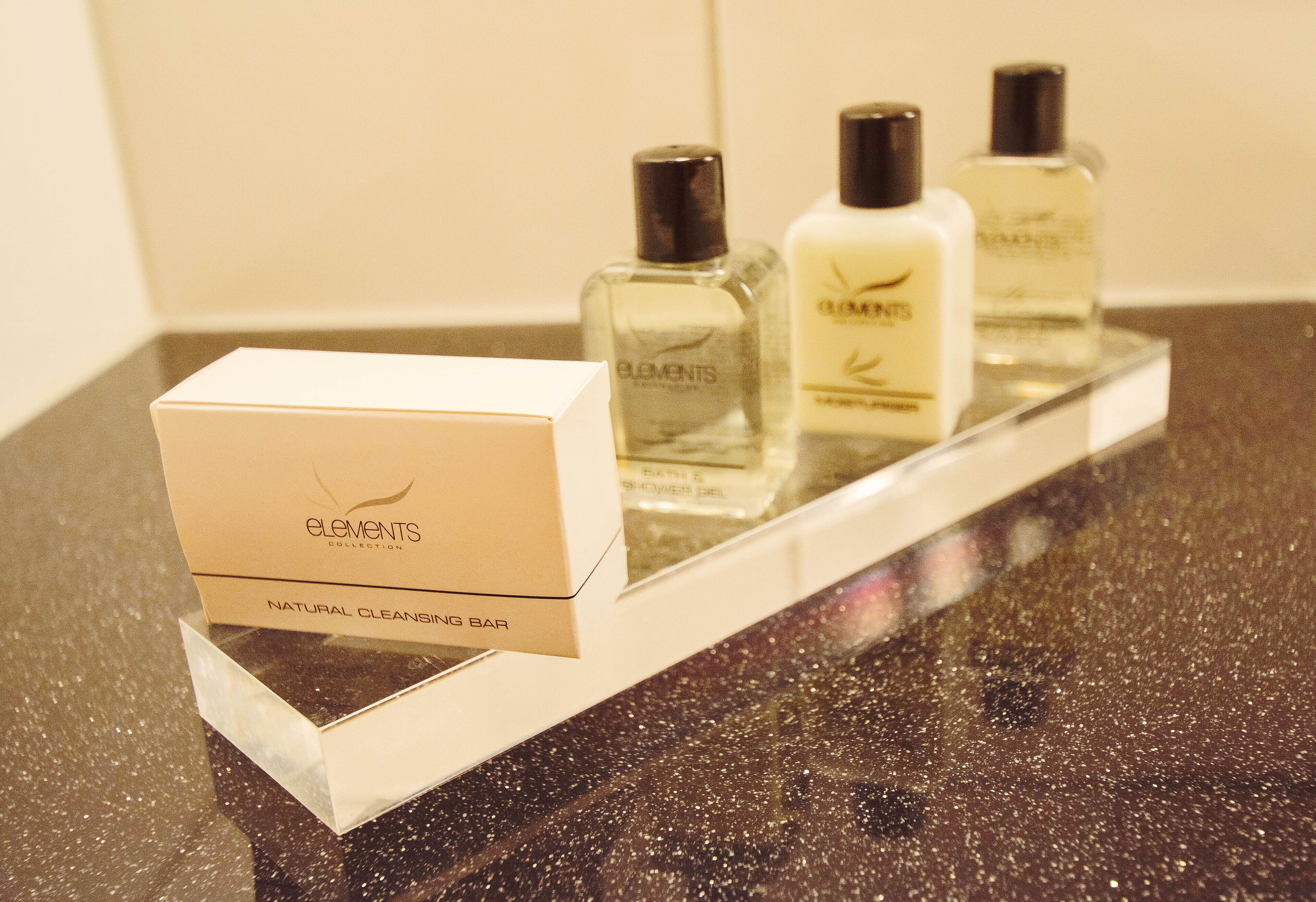 A display of Elements Collection natural cleansing bar products on a countertop.