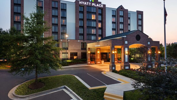 A multi-story hotel with a prominent entrance and a landscaped driveway. - Hyatt Place Baltimore/Owings Mills (Owings Mills)