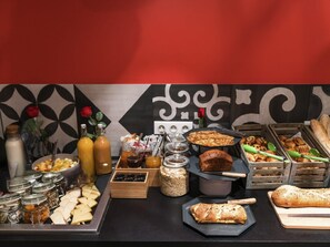 A buffet with various food items, including bread, pastries, and condiments. - ibis Styles Lille Centre Grand Place (Lille)