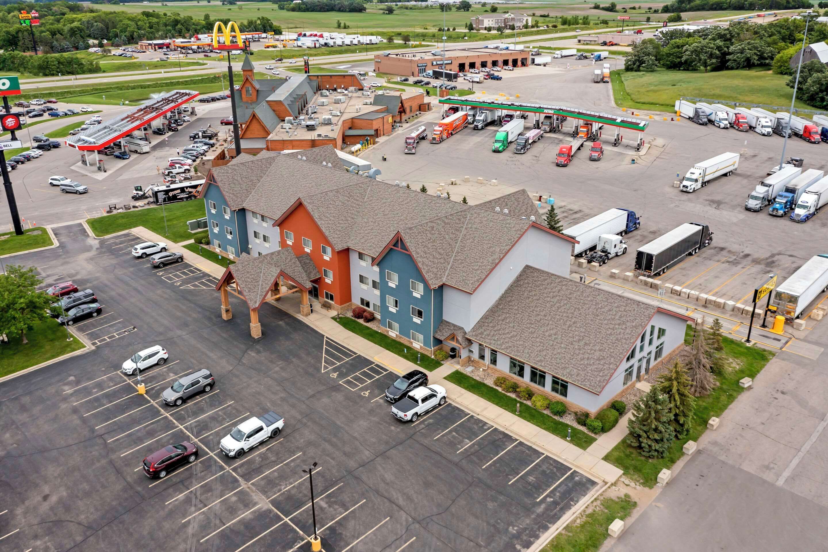 A multi-story building with a parking lot, a gas station, and a McDonald's.