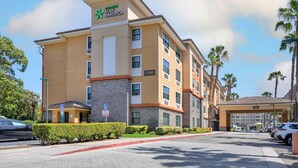 A Stay America hotel with a modern design, multiple floors, and a lobby area. - Extended Stay America Suites Orange County Anaheim Conv Ctr (Anaheim)