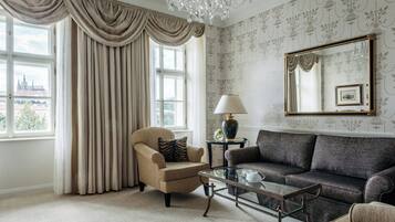 A room with a large window, a sofa, a chair, a coffee table, a lamp, and a mirror.