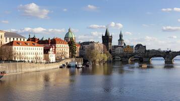 A historic cityscape with a prominent bridge over a river, reflecting the architecture and buildings.