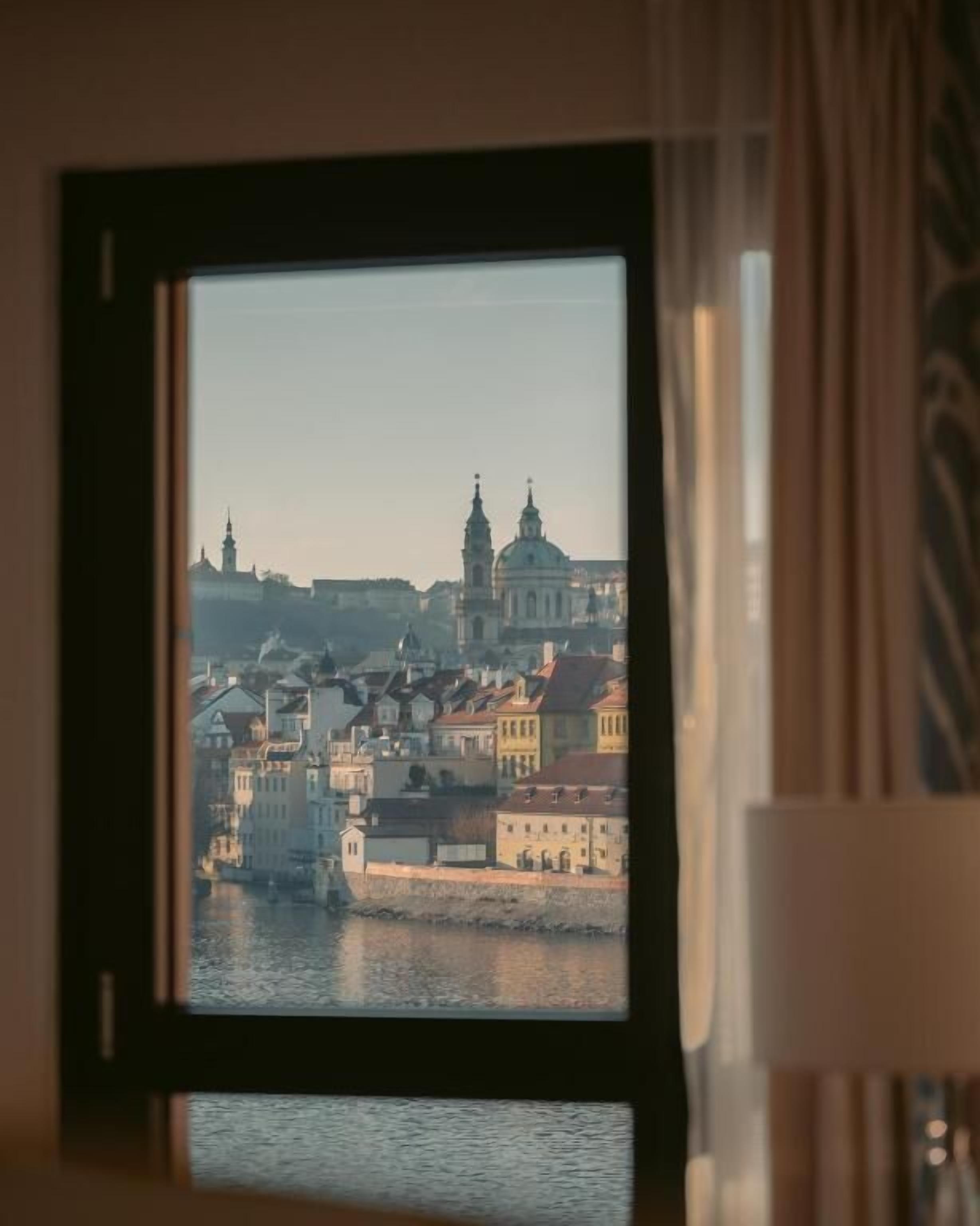 A framed view of a cityscape with buildings and a river.