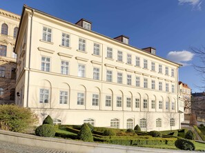 A large, cream-colored building with multiple windows and a symmetrical facade. - Four Seasons Hotel Prague (Prague)