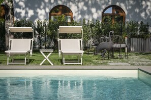 Seasonal outdoor pool, open 10:00 AM to 7:00 PM, pool umbrellas