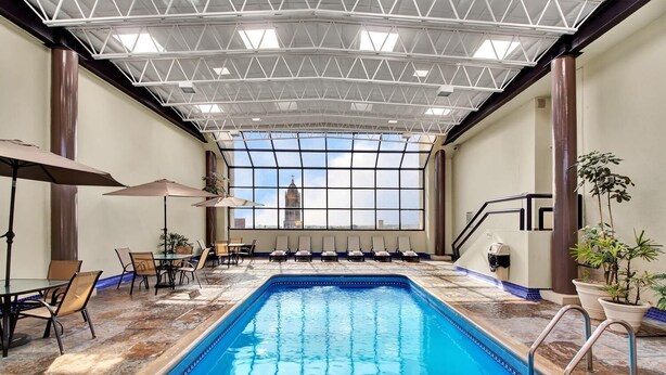 Una piscina interior con vistas a un edificio a través de amplios ventanales.