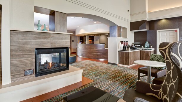 A modern hotel lobby with a fireplace, a reception desk, and a seating area. - Residence Inn by Marriott Los Angeles LAX/El Segundo (El Segundo)