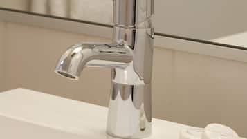 A modern bathroom sink with a chrome faucet and two soap bars.
