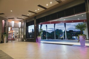 Enter a spacious, open lobby with a stunning view of the surrounding area.