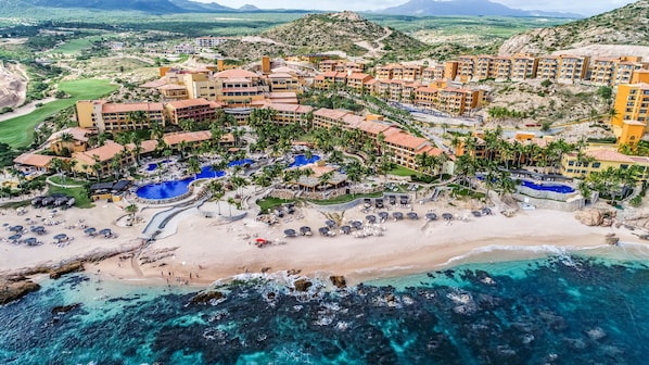 An aerial view of a resort with multiple buildings, a beach, and a pool area. - Grand Fiesta Americana Los Cabos All Inclusive Golf & Spa (Cabo San Lucas)