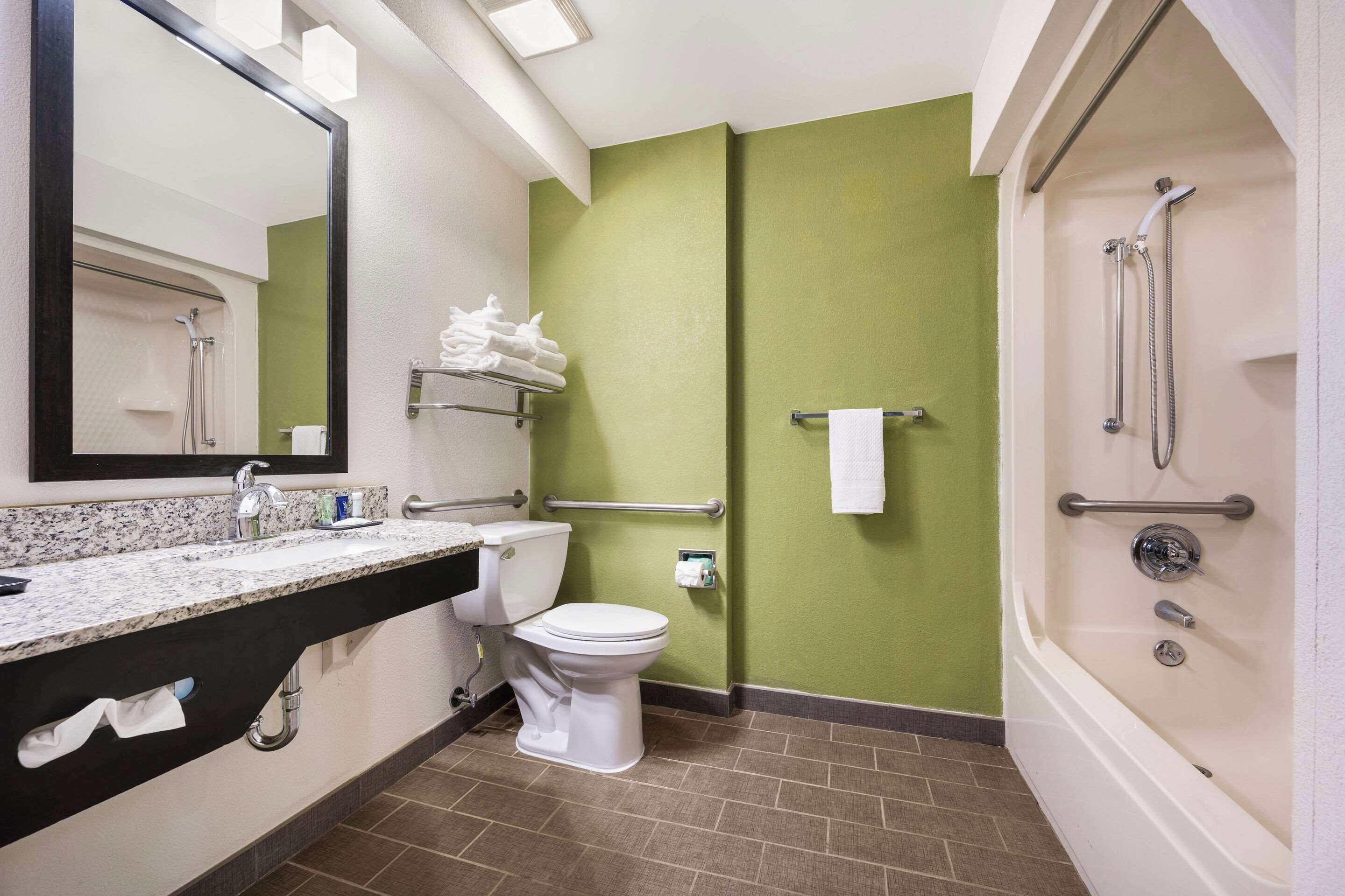 A bathroom with a toilet, sink, and shower.