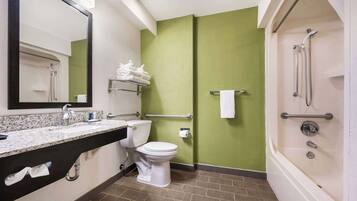 A bathroom with a toilet, sink, and shower.