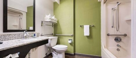A bathroom with a toilet, sink, and shower.