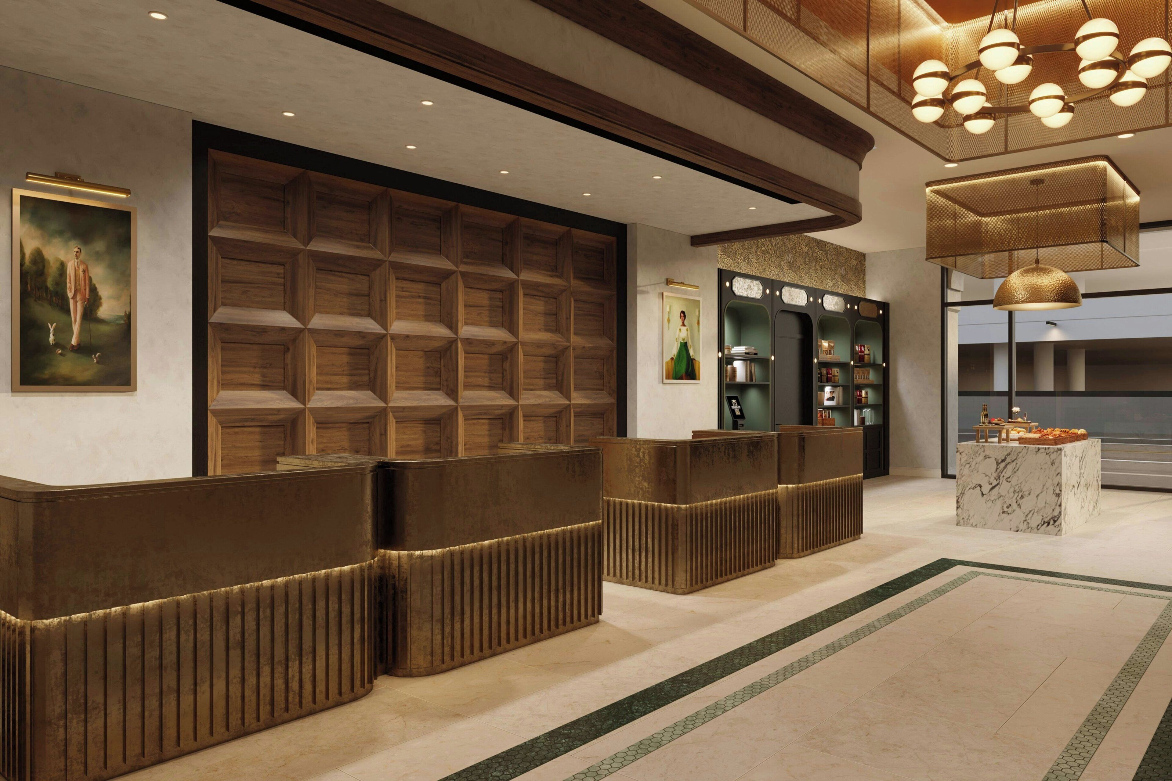 A reception area with a wooden reception desk, a framed painting, and a modern chandelier.