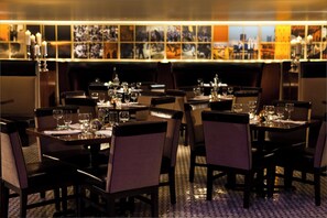 Enjoy meals in a warm and inviting dining area with comfortable seating and elegant table settings.