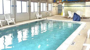 An indoor swimming pool with clear water, marked lanes, and white lounge chairs. - Comfort Inn & Suites Jackson North (Jackson)