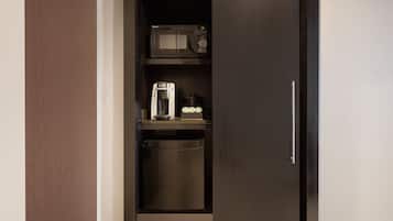 A compact kitchen with a microwave, coffee maker, and dishwasher.