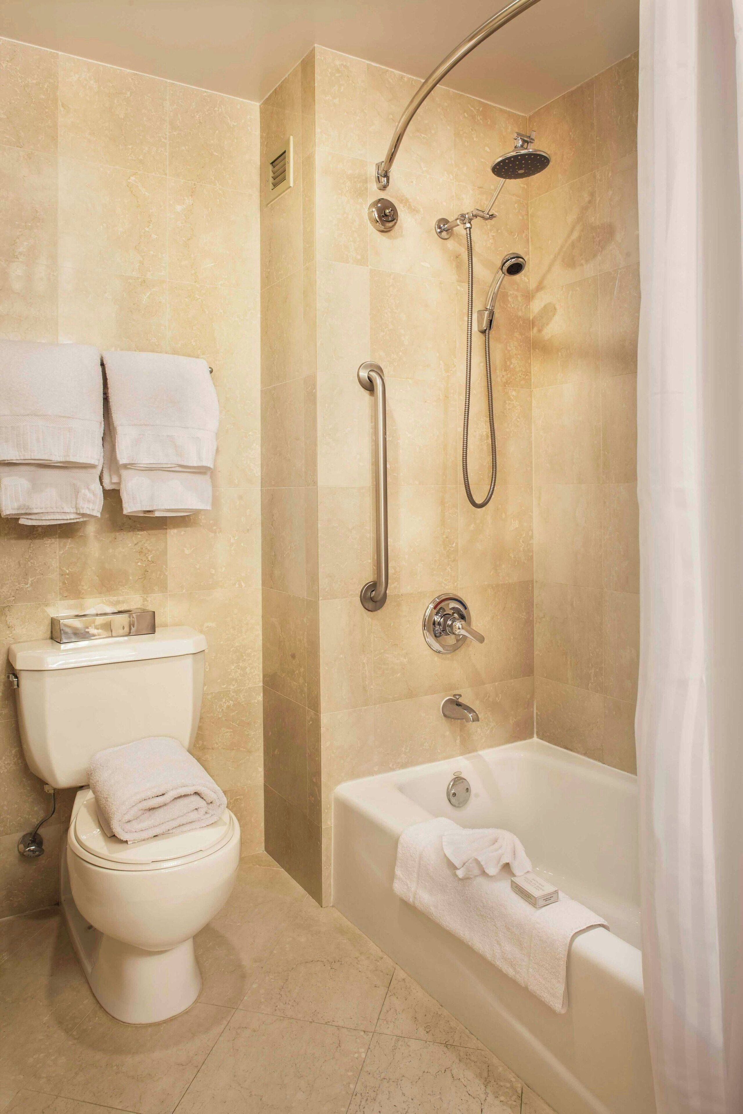 suite, 1 king bed with sofa bed, non smoking | bathroom | combined shower/bathtub, rainfall showerhead, free toiletries