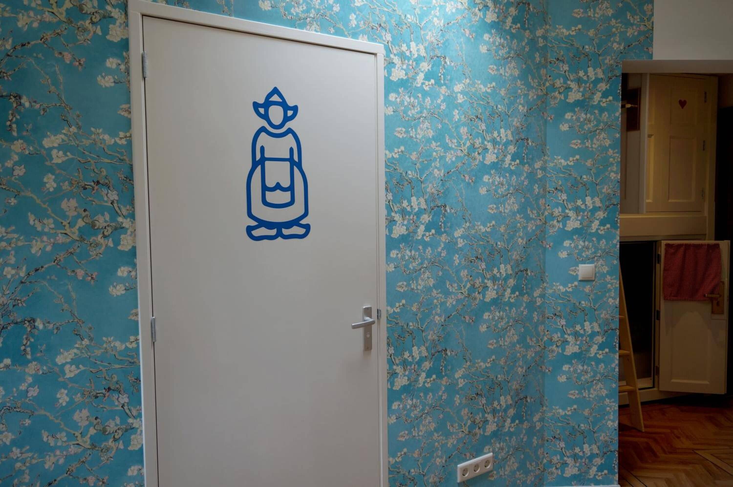 A door with a simple line drawing of a person.