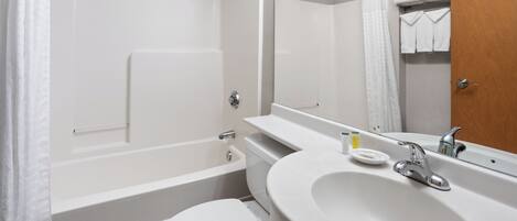 A modern bathroom with a bathtub, toilet, and sink.