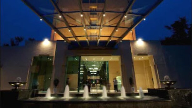 A modern building with a glass facade and a covered entrance area. - Blue Diamond - IHCL SeleQtions (Pune)