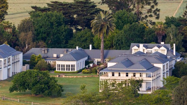 A large, modern residential complex with multiple houses, each featuring a distinct architectural style with gabled roofs and large windows. - Chateau Yering Hotel (Yering)