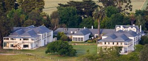 A large, modern residential complex with multiple houses, each featuring a distinct architectural style with gabled roofs and large windows. - Chateau Yering Hotel (Yering)