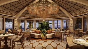 A spacious dining area with high ceilings, large windows, and a central seating area with a plant. - Maroma, A Belmond Hotel, Riviera Maya (Playa del Carmen)