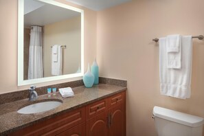 A bathroom with a sink, mirror, towel rack, and toilet. - Vistana Beach Club (Jensen Beach)
