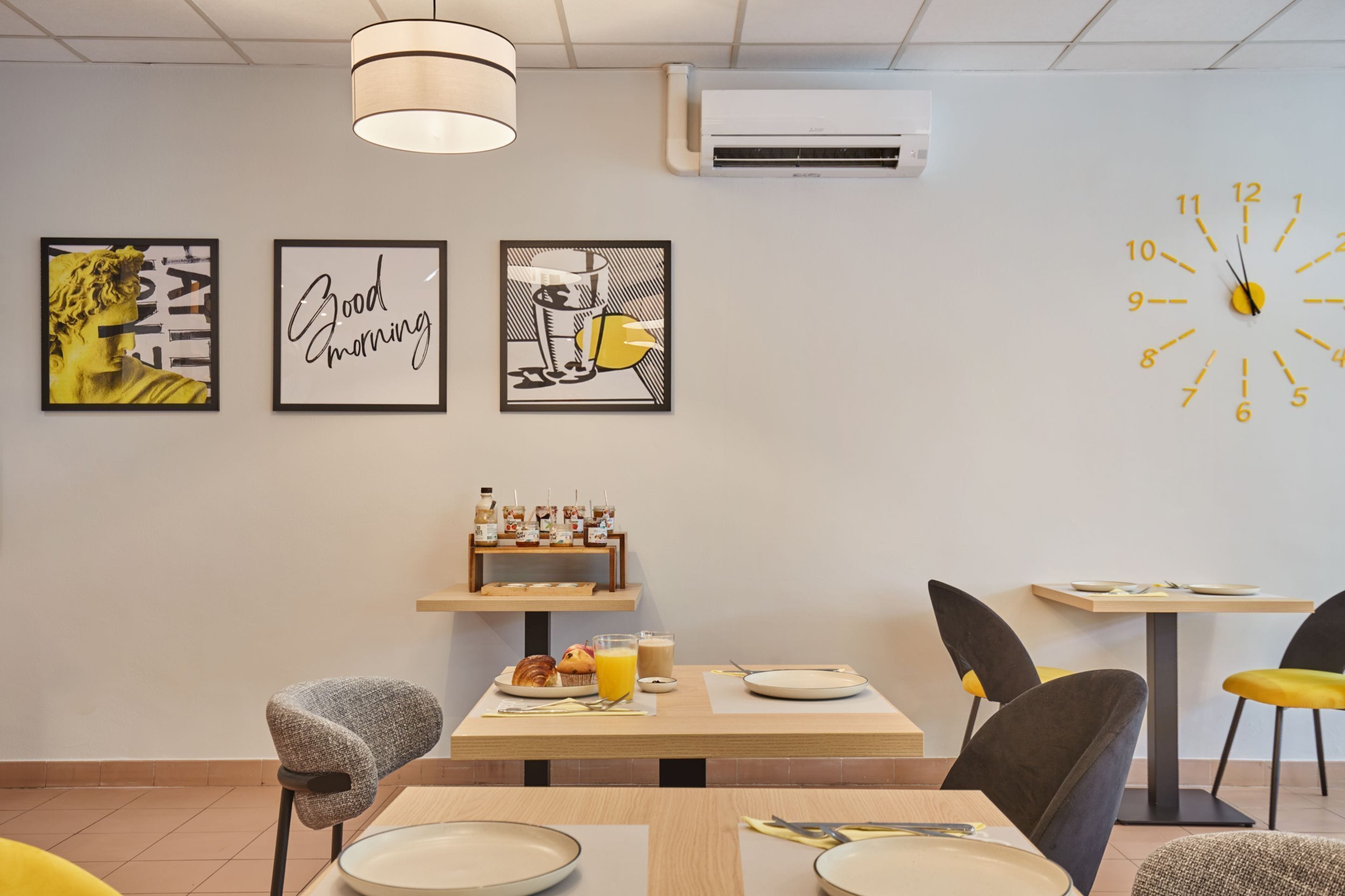 A breakfast setting with a table, chairs, and a clock on the wall.