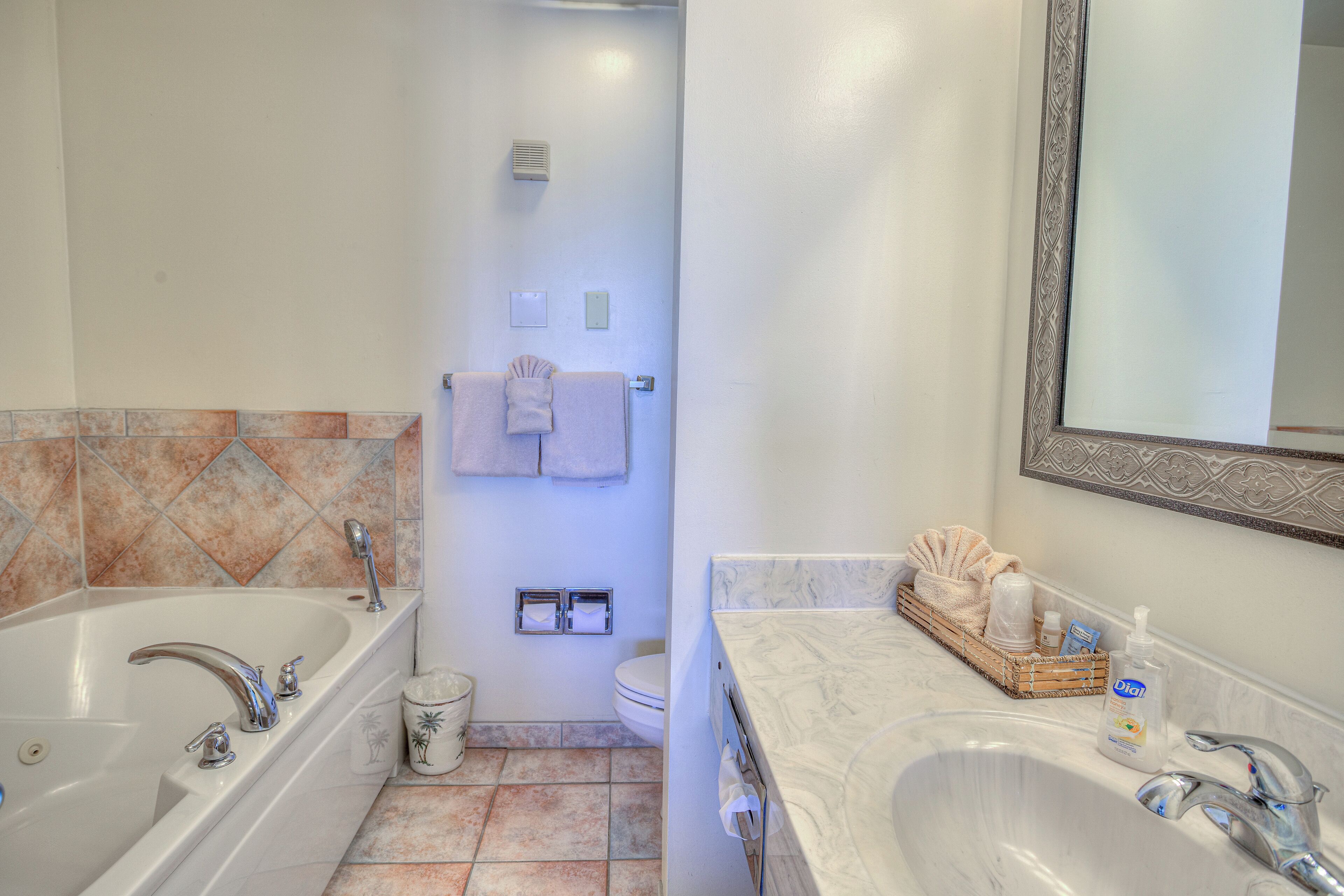 A bathroom with a bathtub, a sink, and a toilet.