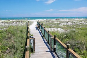 A wooden boardwalk leading to a beach with a clear view of the ocean. - La Fiesta Ocean Inn And Suites (St. Augustine)