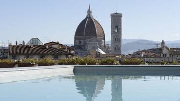 Seasonal outdoor pool, open 9:00 AM to 7:00 PM, pool umbrellas