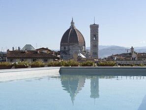Seasonal outdoor pool, open 9:00 AM to 7:00 PM, pool umbrellas
