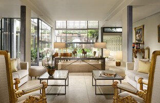 A spacious living room with a large window, two sofas, a coffee table, and decorative items.