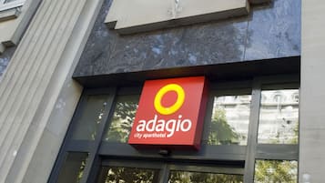 A building with a sign for 'adagio city aparthotel' and the number '131' on the window.