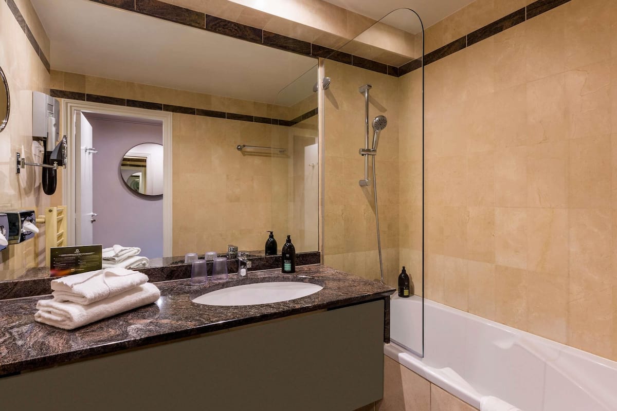 Bathtub, eco-friendly toiletries, hair dryer, towels