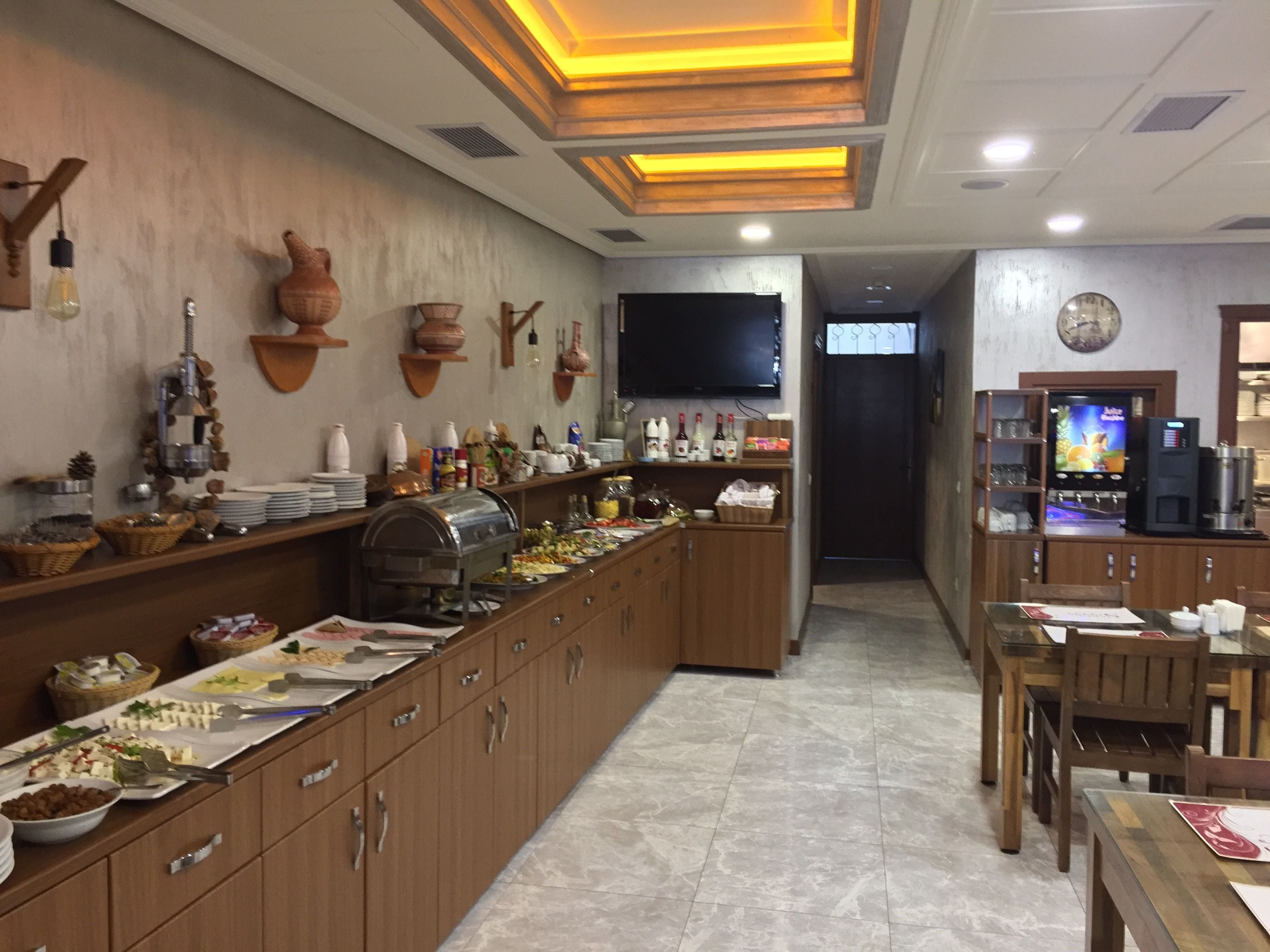 A buffet setup with various food items and a coffee machine.