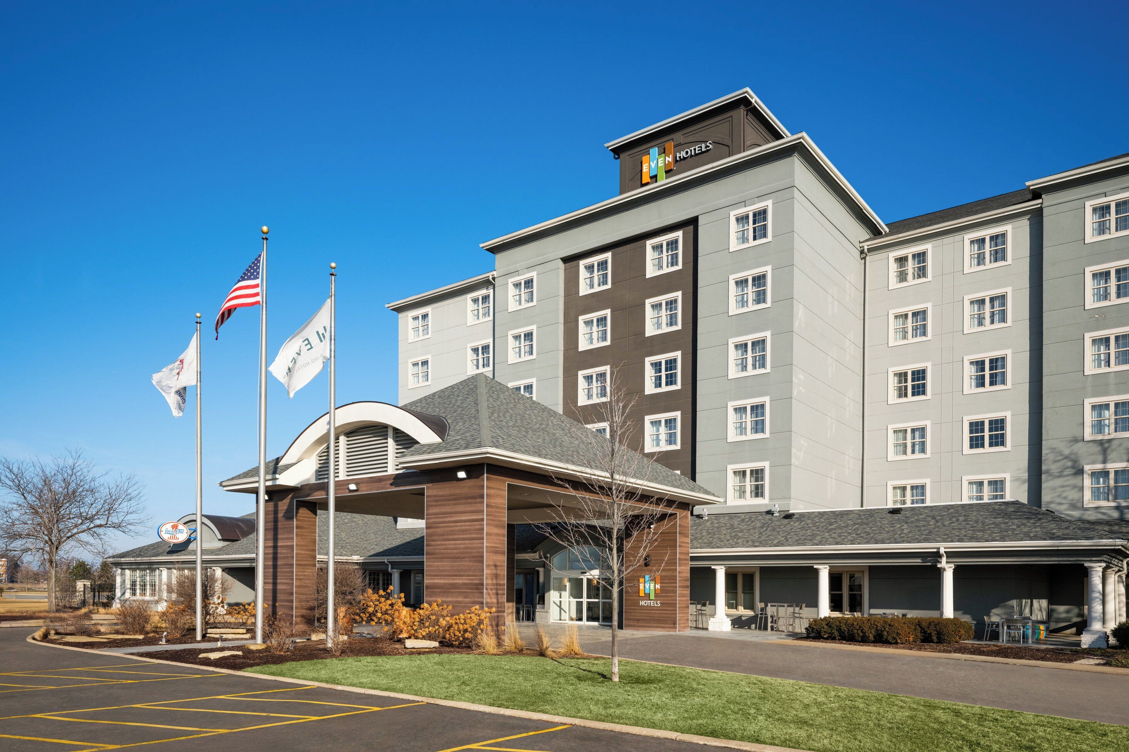 A hotel with a modern design, multiple floors, and a covered entrance.