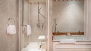 A modern bathroom with a glass-enclosed shower, a standalone sink, and a bathtub.