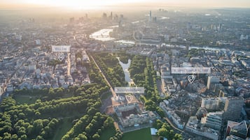 An aerial view of a cityscape with Buckingham Palace, St. James' Court, and the West End area.