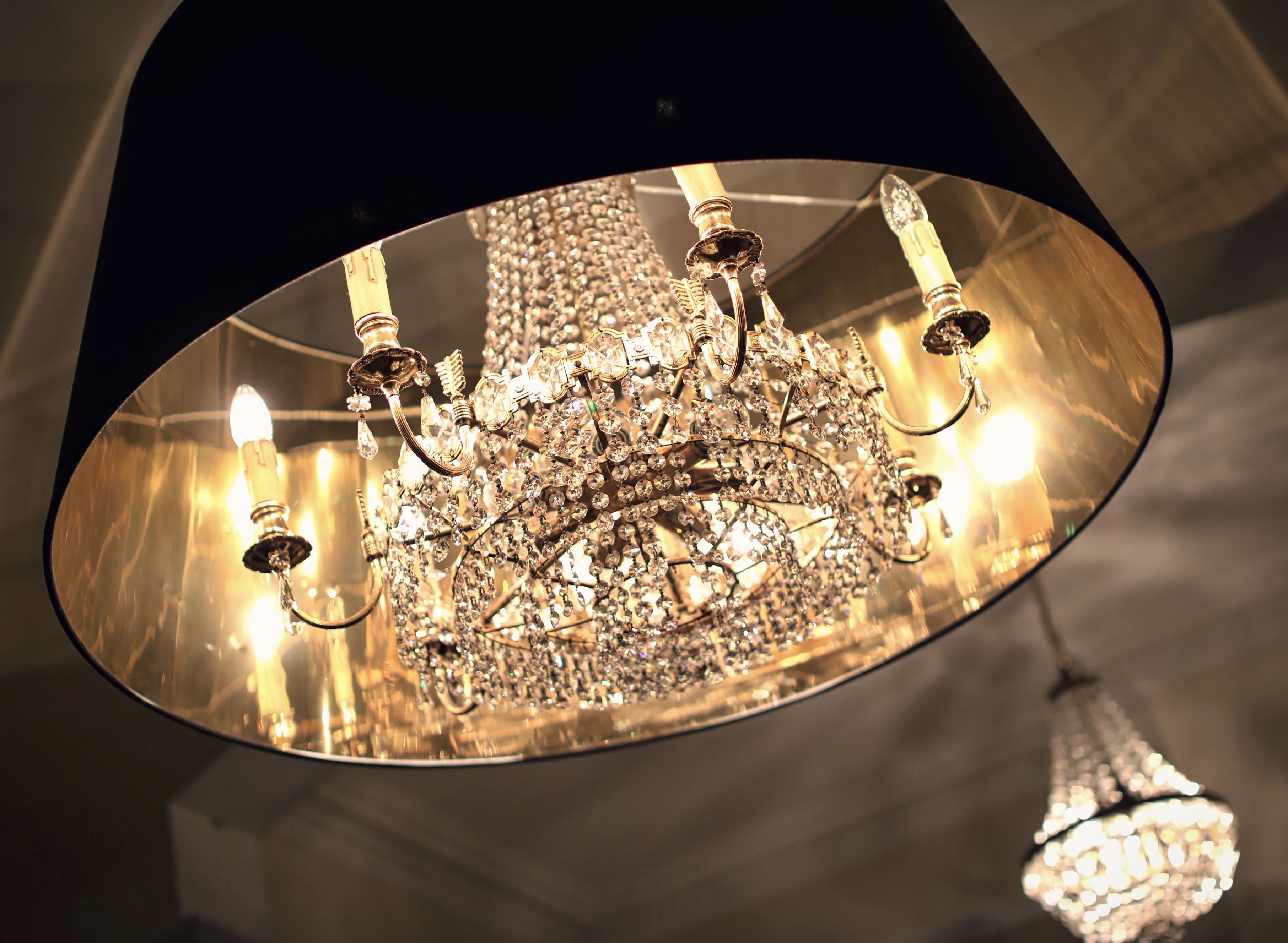 A chandelier with multiple arms and crystal decorations.