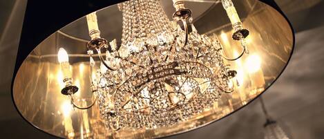 A chandelier with multiple arms and crystal decorations.