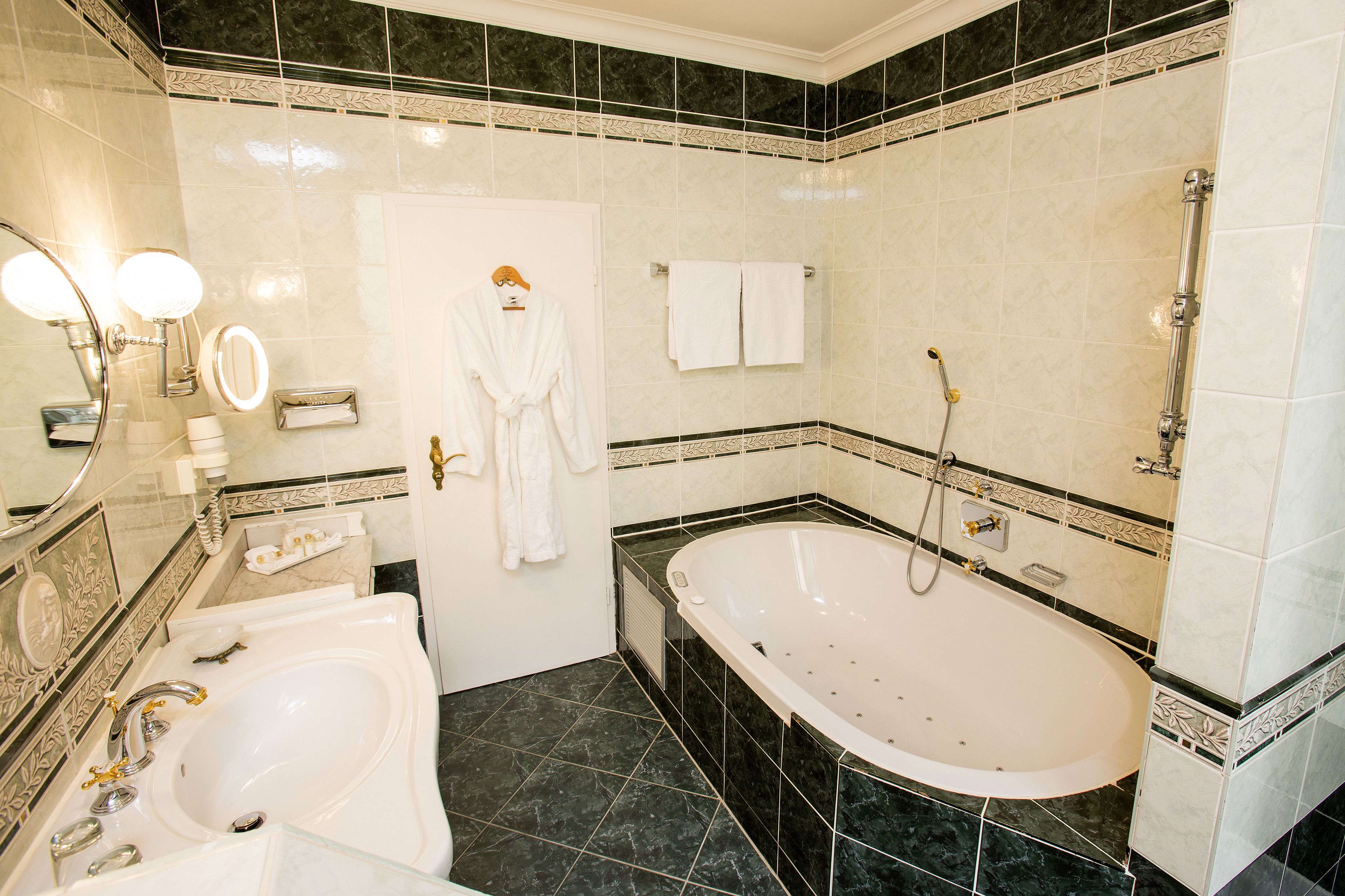 A bathroom with a bathtub, a sink, and a mirror.