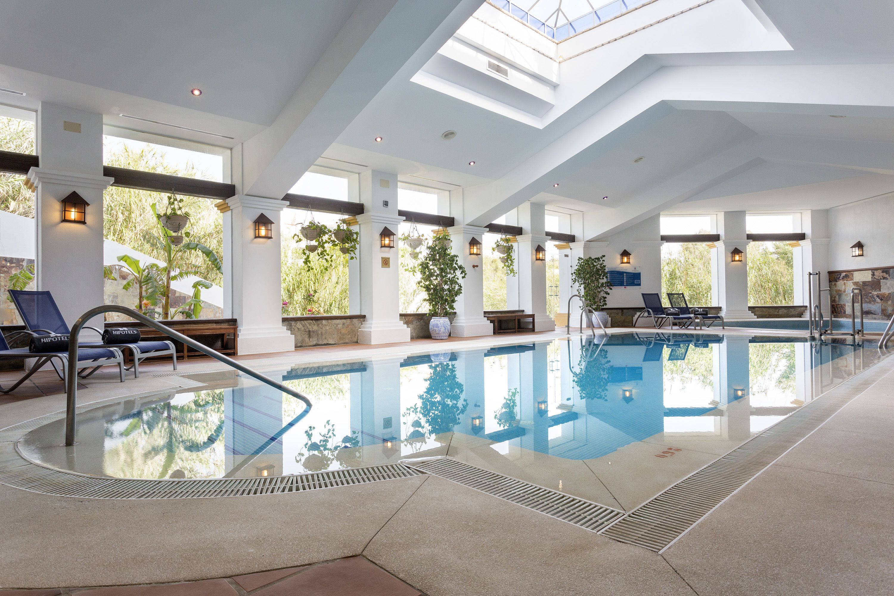 indoor pool, outdoor pool, pool umbrellas, pool loungers