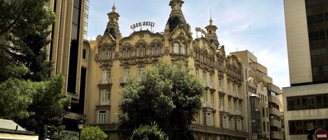 A historic building with ornate architectural details, including multiple spires and decorative elements.